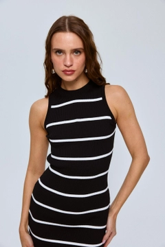 A wholesale clothing model wears tbu12631-striped-zero-sleeve-midi-knit-dress-black, Turkish wholesale Dress of Tuba Butik