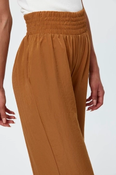 A wholesale clothing model wears tbu11771-wide-leg-flowy-tan-women's-trousers-camel, Turkish wholesale Pants of Tuba Butik