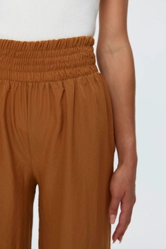 A wholesale clothing model wears tbu11771-wide-leg-flowy-tan-women's-trousers-camel, Turkish wholesale Pants of Tuba Butik