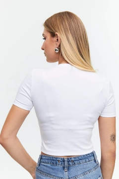 Ein Bekleidungsmodell aus dem Großhandel trägt tbu12534-basic-crew-neck-short-sleeve-women's-crop-white, türkischer Großhandel Oberteil von Tuba Butik