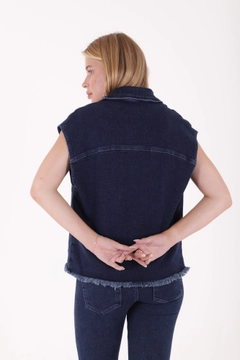 A wholesale clothing model wears xlo10220-buttoned-front-tasseled-denim-vest-dark-blue, Turkish wholesale Vest of XLove